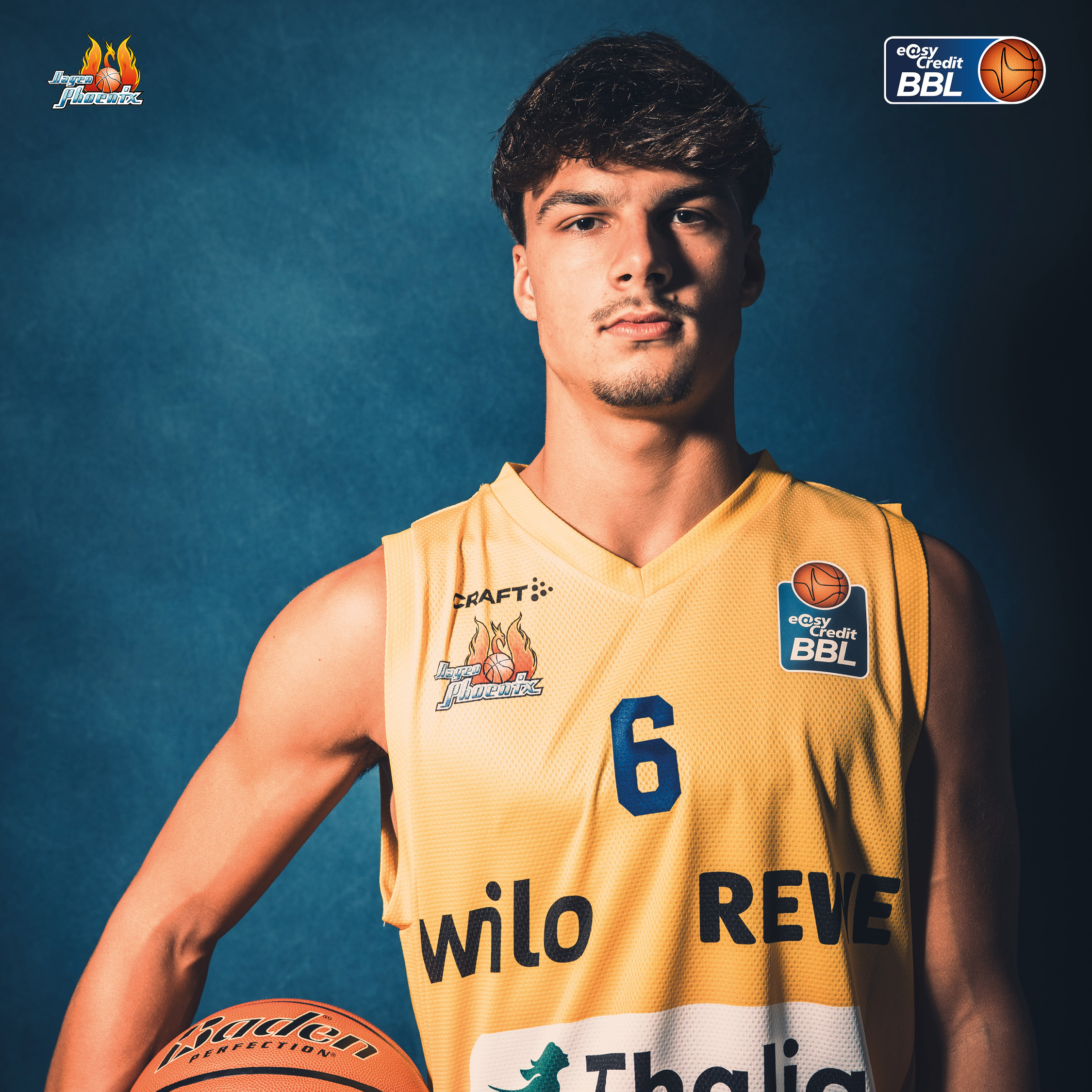 Junger Basketballspieler mit gelbem Trikot Nummer 6 haelt einen Ball